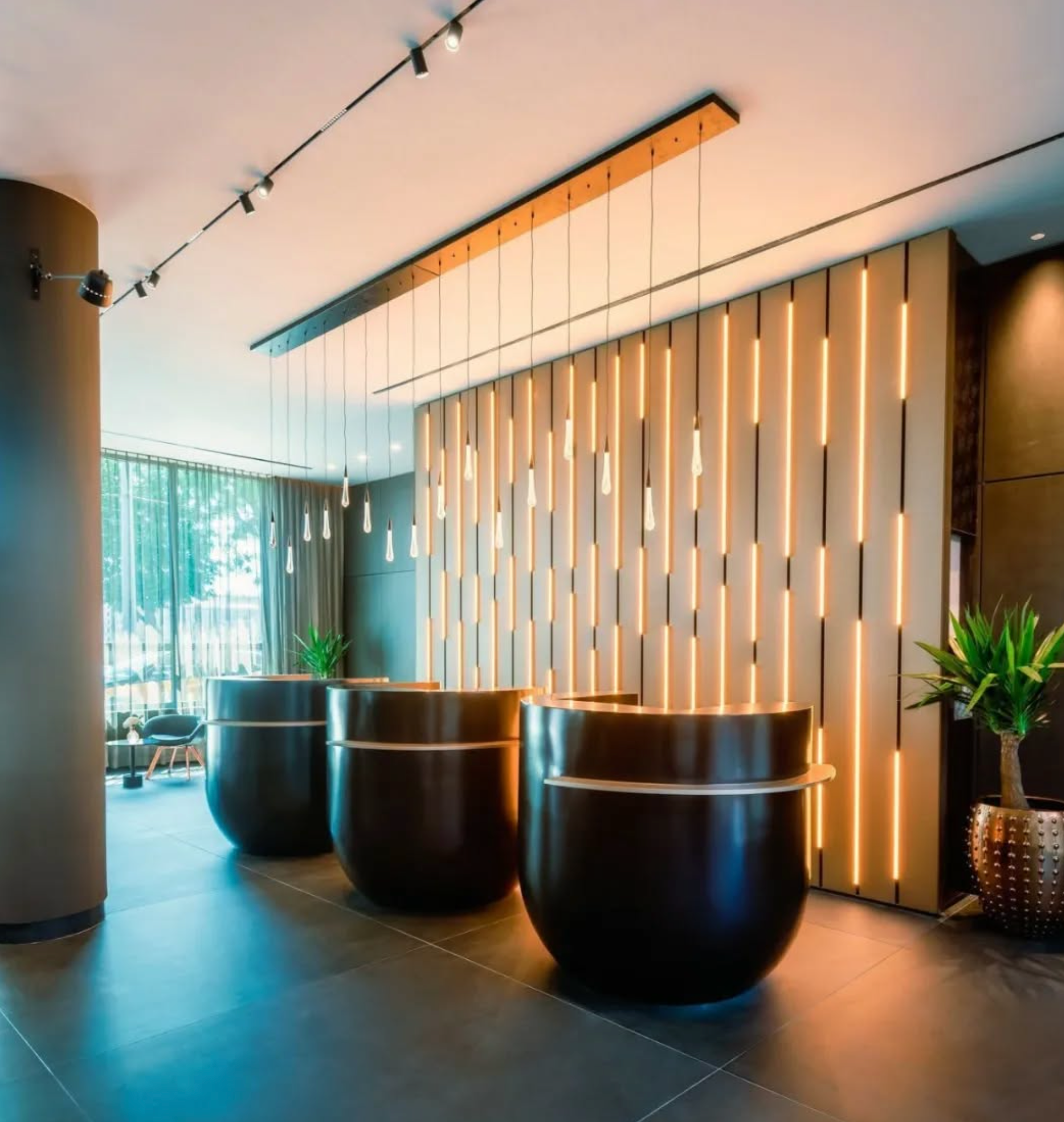 Luxury hotel lobby illuminated with decorative chandeliers and layered hospitality lighting design